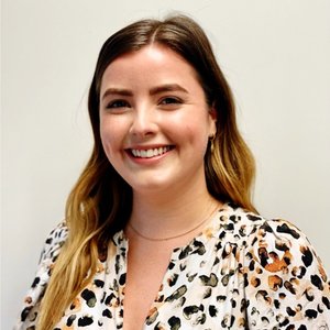 Female real estate agent smiling after successful AI-led client call with help of invector ai